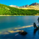 Scenic mountain lake near Denver surrounded by pine forests and rocky peaks, showcasing Colorado’s natural beauty in every season.