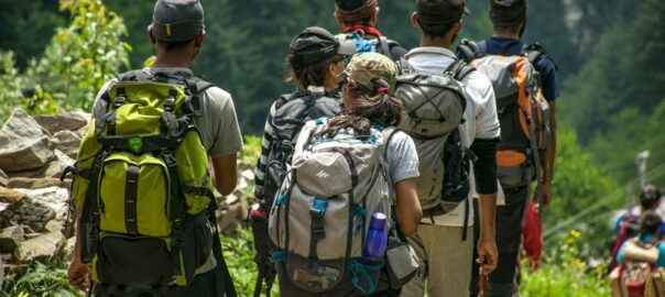 Group of hikers with backpacks walking on a forest trail near Denver, Colorado