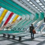 Solo traveler walking through a colorful modern transit station in Denver during a safe solo travel adventure in 2026