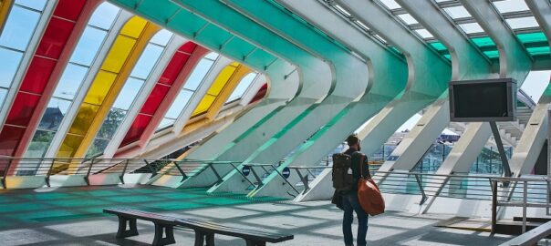 Solo traveler walking through a colorful modern transit station in Denver during a safe solo travel adventure in 2026